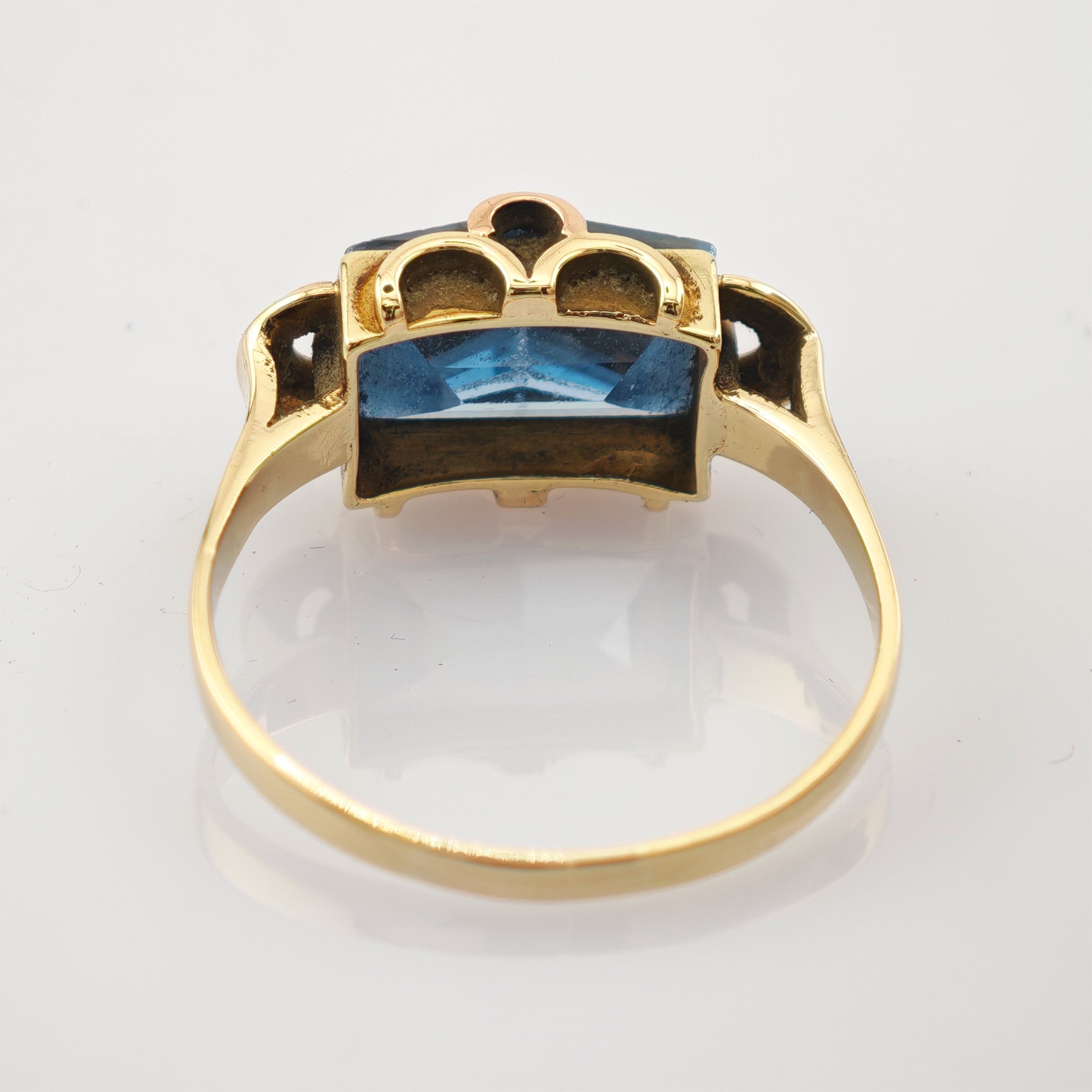 Goldring mit rechteckigem blauem Edelstein und detaillierter Fassung im Vintage-Design.