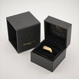 Offene schwarze Schmuckbox mit goldenem Ring auf schwarzem Samtkissen neben geschlossener Box mit Ihrem Vintage-Logo
