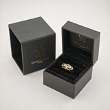 Schwarze Schmuckschachteln mit goldenem 'W'-Logo und Text 'YourVintage Store', offene Schachtel zeigt goldenen Ring mit drei klaren rechteckigen Edelsteinen.