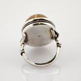 Silberring mit großem, transluzentem braun-gelbem Stein in gezwirbelter Zargenfassung, Punze 925