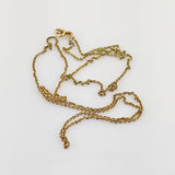 Verwickelte goldene Halskette mit feinem Gliederdesign und kleinem Verschluss auf weißem Hintergrund