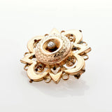 Verzierte Vintage-Goldbrosche mit zentralem, diamantähnlichem Stein und floralen Mustern