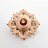 Verzierte Vintage-Goldbrosche mit zentralem, diamantähnlichem Stein und floralen Mustern