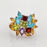 Silberring mit farbigen Edelsteinen in Blütenform