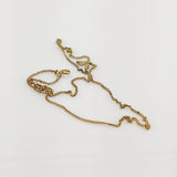 Feine Goldkette mit zierlichem Federringverschluss auf weißem Hintergrund