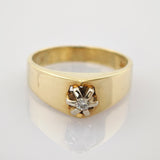 Goldener Ring mit funkelndem Diamanten in sechszackiger Fassung