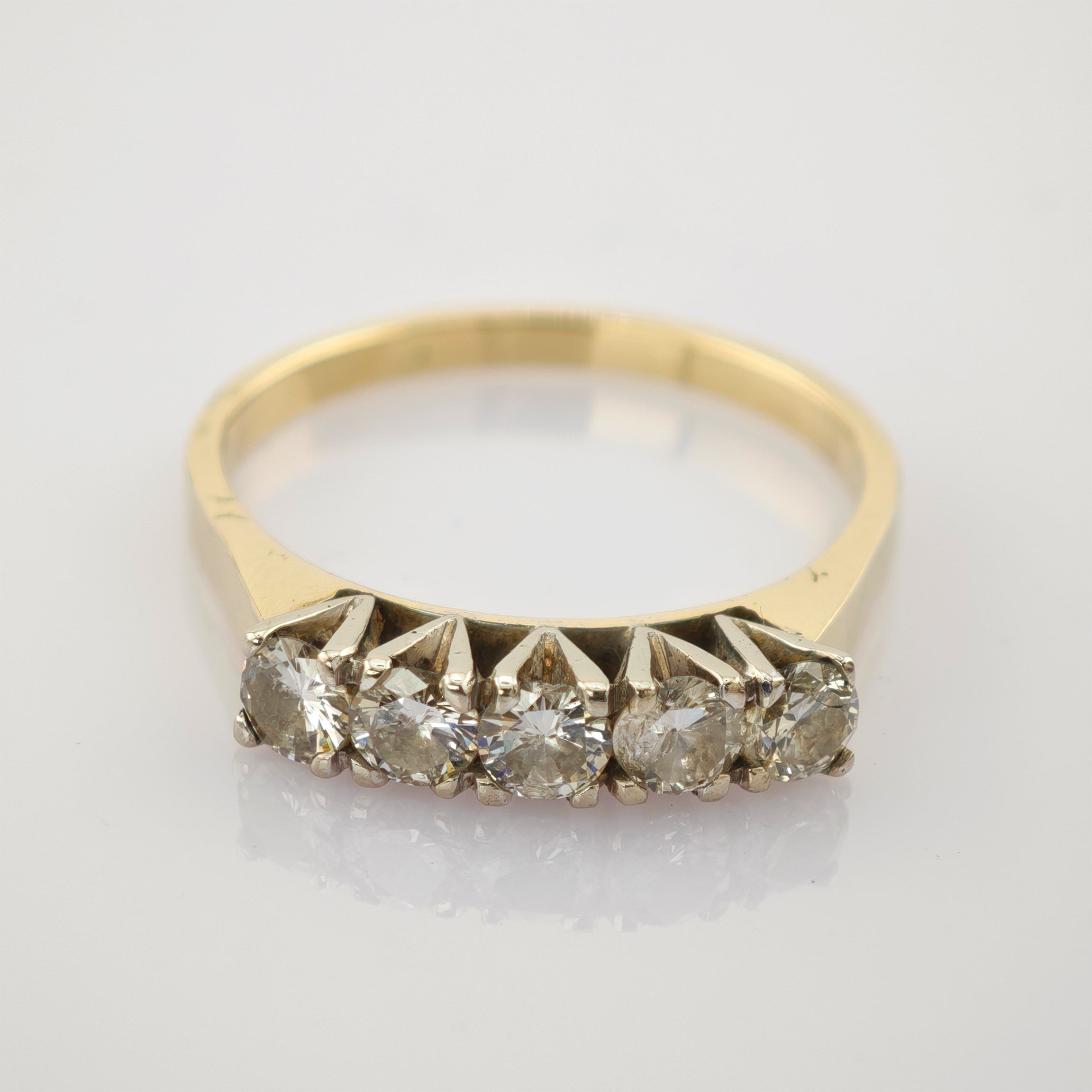 Goldener Ring mit fünf rund geschliffenen Diamanten in einer Reihe