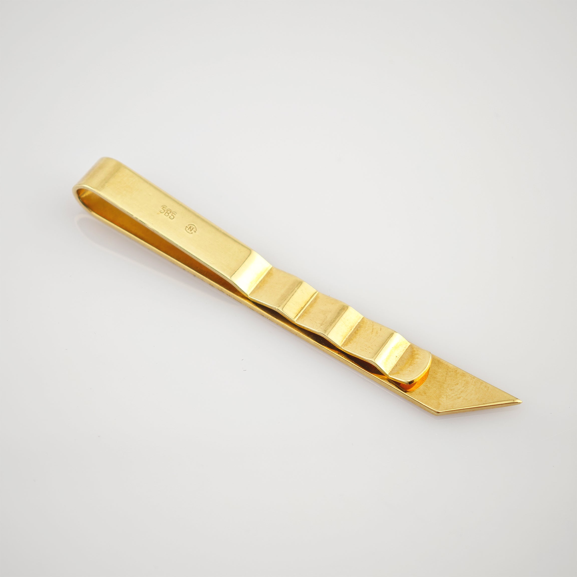 Goldfarbener Metallclip mit polierter Oberfläche und fünf erhabenen Rillen, graviert mit 585 und N.