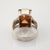 Silberner Ring mit rechteckigem, bernsteinfarbenem Stein und geteiltem Band mit strukturierter Innenseite