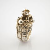 Silberring mit Froschdesign und Krone auf kopfsteinpflasterförmigem Band